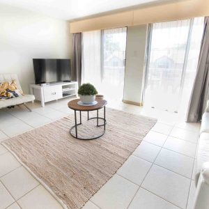 Bright Coastal Living Room with Balcony Access - Nelson Bay Breeze Accommodation